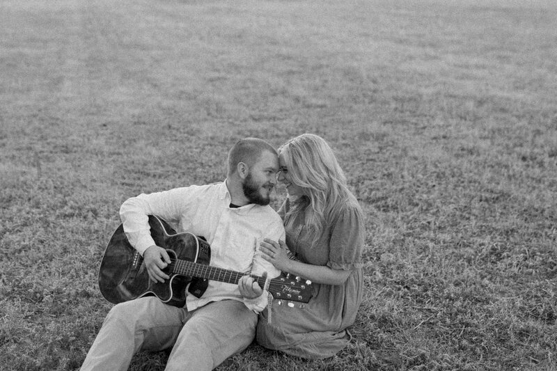 couple in field with guitar