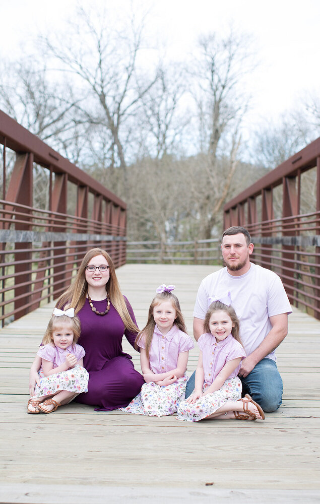 The whole family sitting down at the park - St Augustine family photoshoot