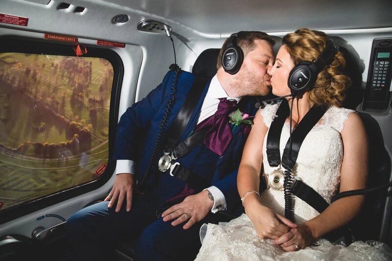 photo of a bride and groom kissing in a helicopter on their cheshire wedding day