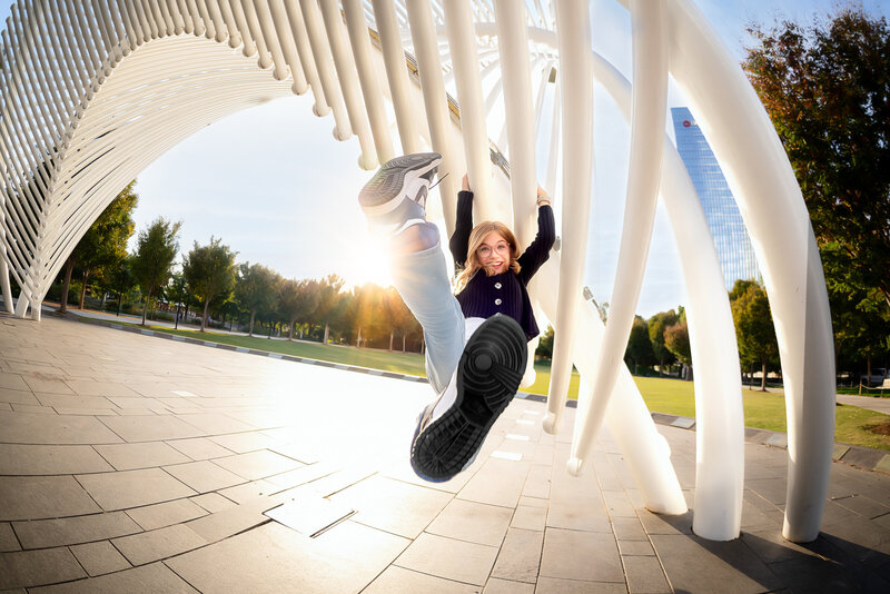 A family of five swings their children in the art at an urban location in Oklahoma City.
