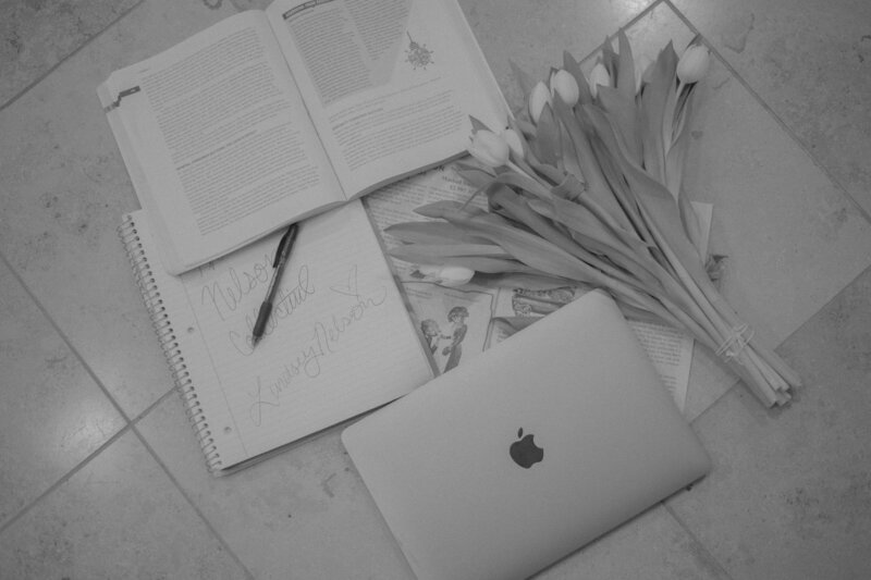 The Nelson Collective work computer with flowers and branding materials