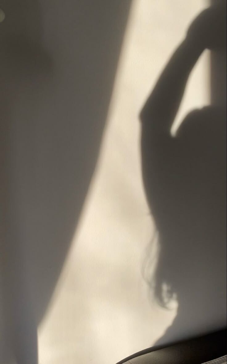 Image of a woman's shadow against the wall