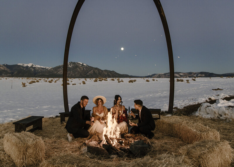 couples roasting smores around a campfire after eloping in colorado