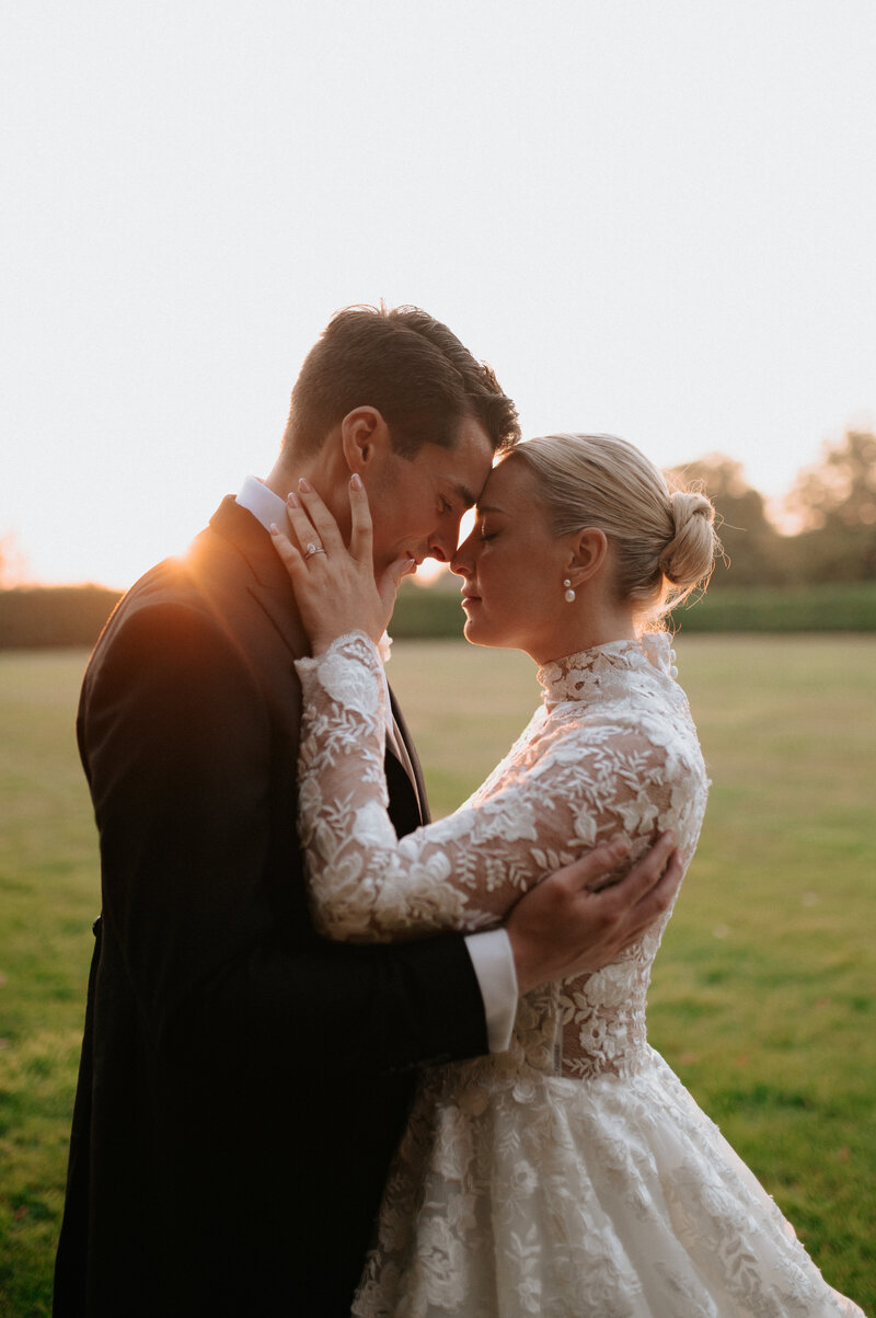 Bride and groom share quiet sunset moment during Norfolk wedding