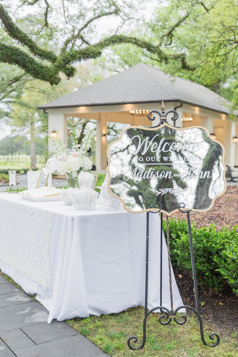 a welcome sign and table for an outdoor wedding