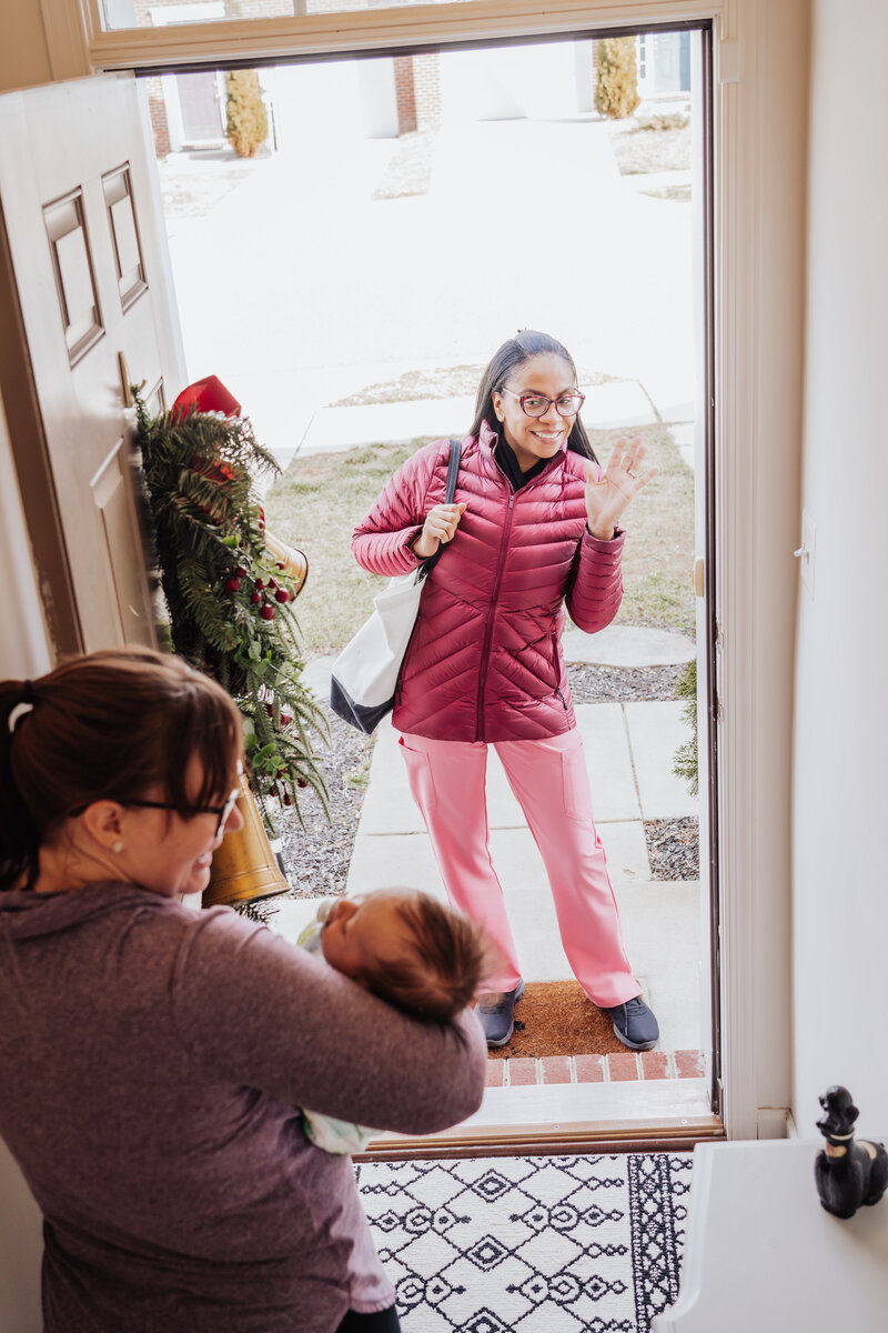 Doula visiting someone's house postpartum. The Mother and baby answer the door