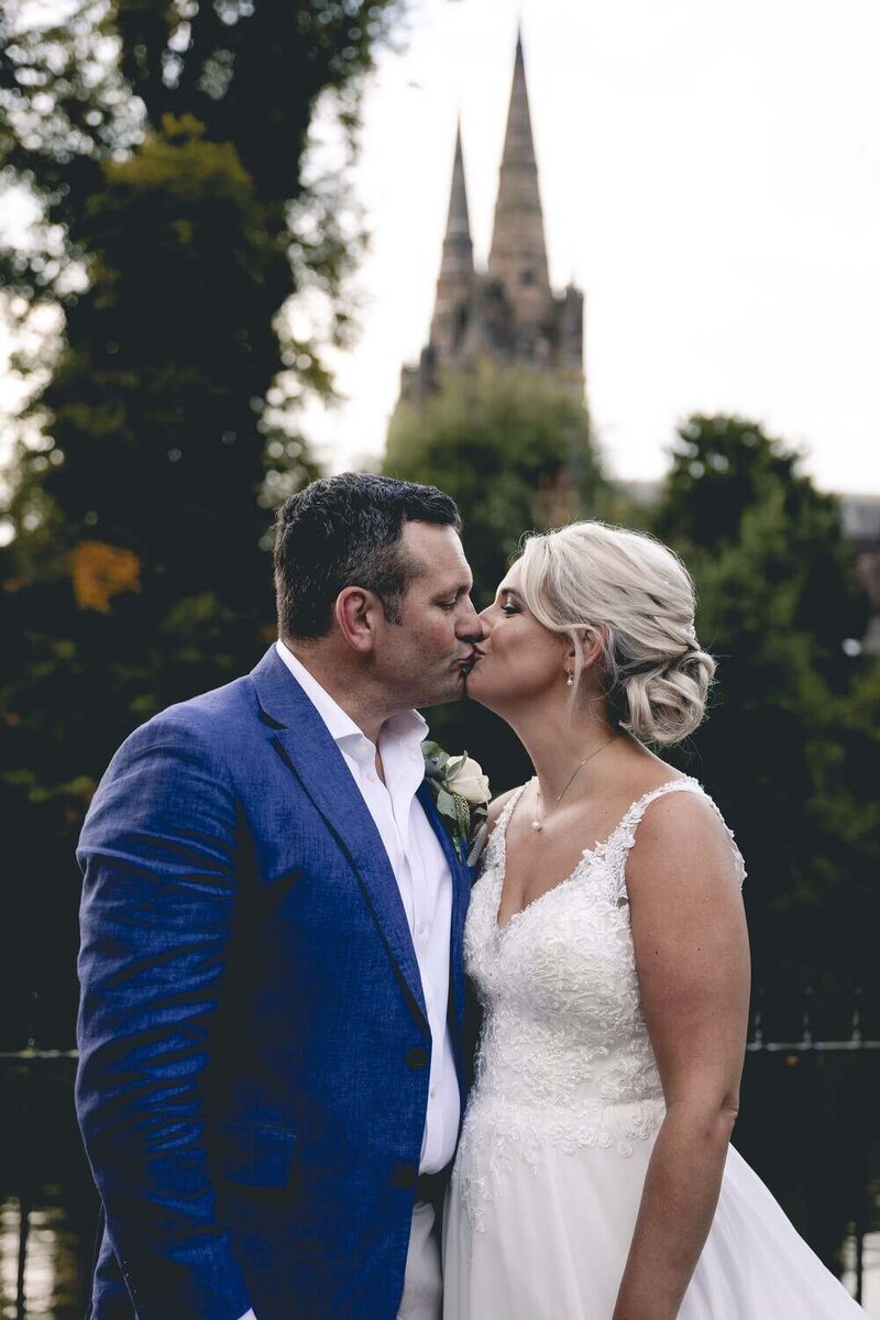 Bride & Groom kiss in front of Lichfield Cathedral