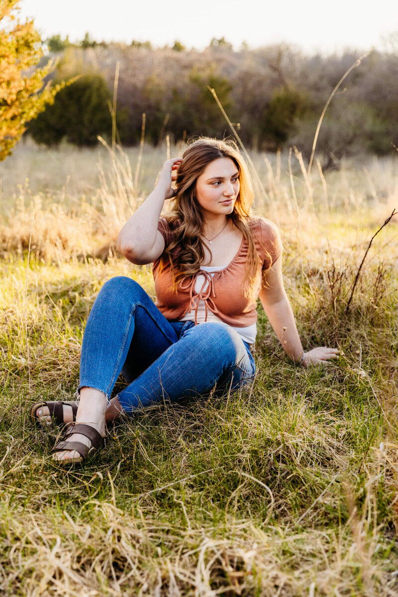 Beautiful senior posing in a field by Ashley Kalbus