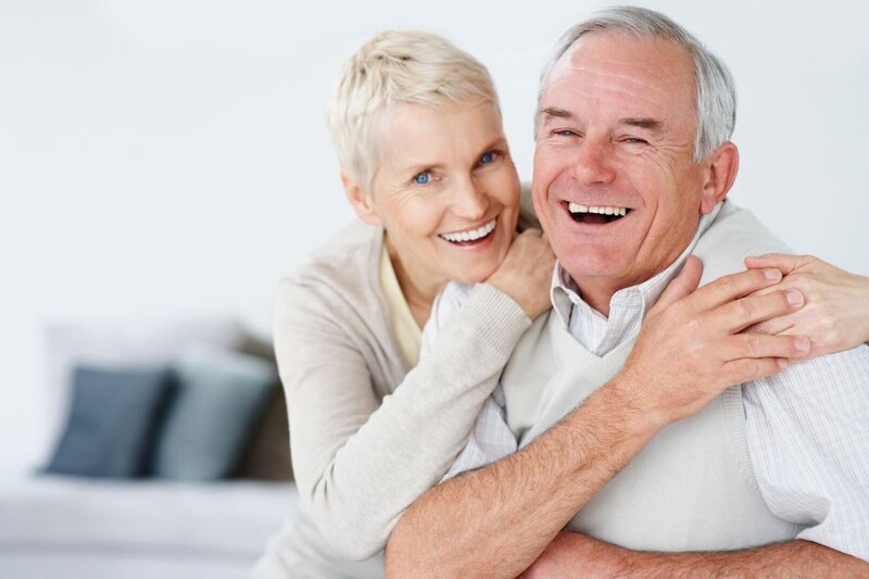 Happy couple laughing and smiling with their beautiful white smiles.