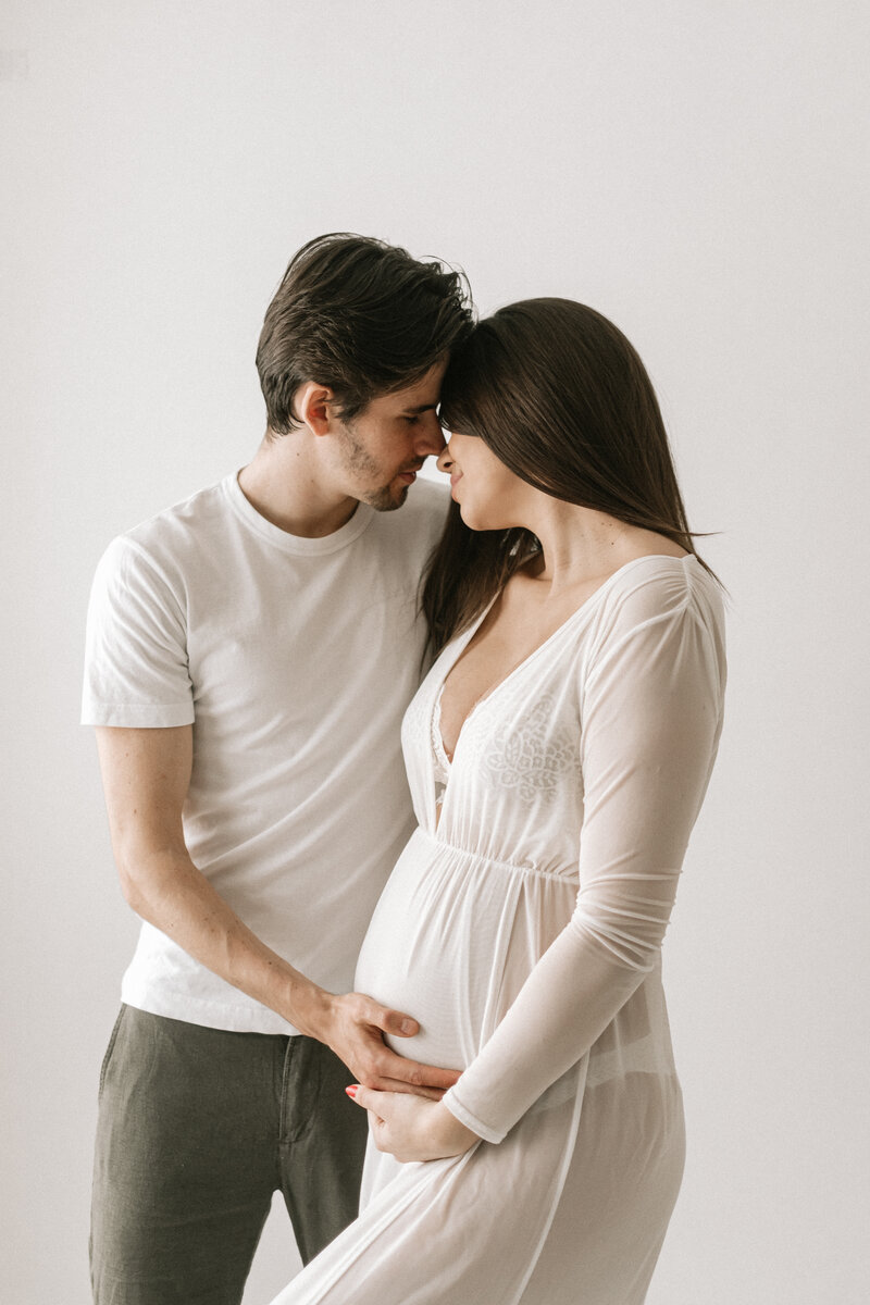 Expectant mother looks into her partner's eyes during a maternity shoot