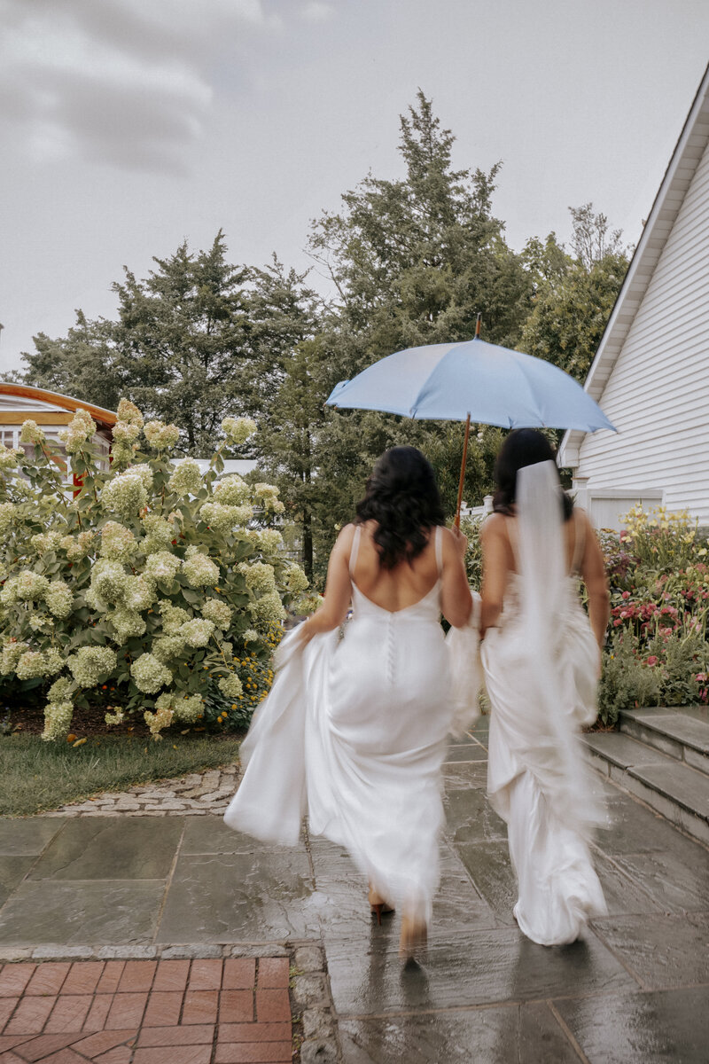 luxury-lgbtq-wedding-maryland-two-brides-holding-umbrella