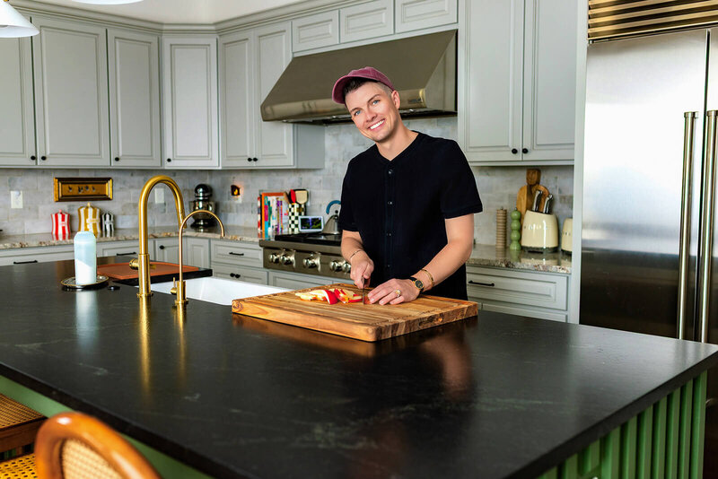 Madison Wetter, Cave Creek real estate agent, smiling while preparing food in a modern kitchen, showcasing lifestyle and home spaces.
