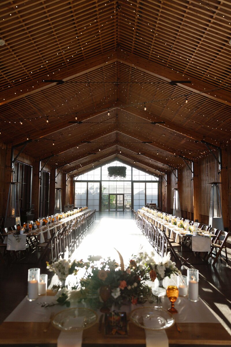 Indoor wedding reception tables with royal style seating.