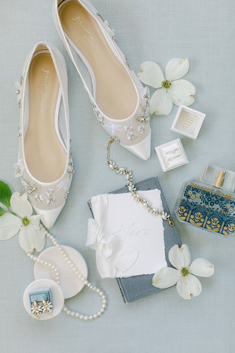 Soft blue linen flat lay mat styled with romantic paper goods and silk ribbon