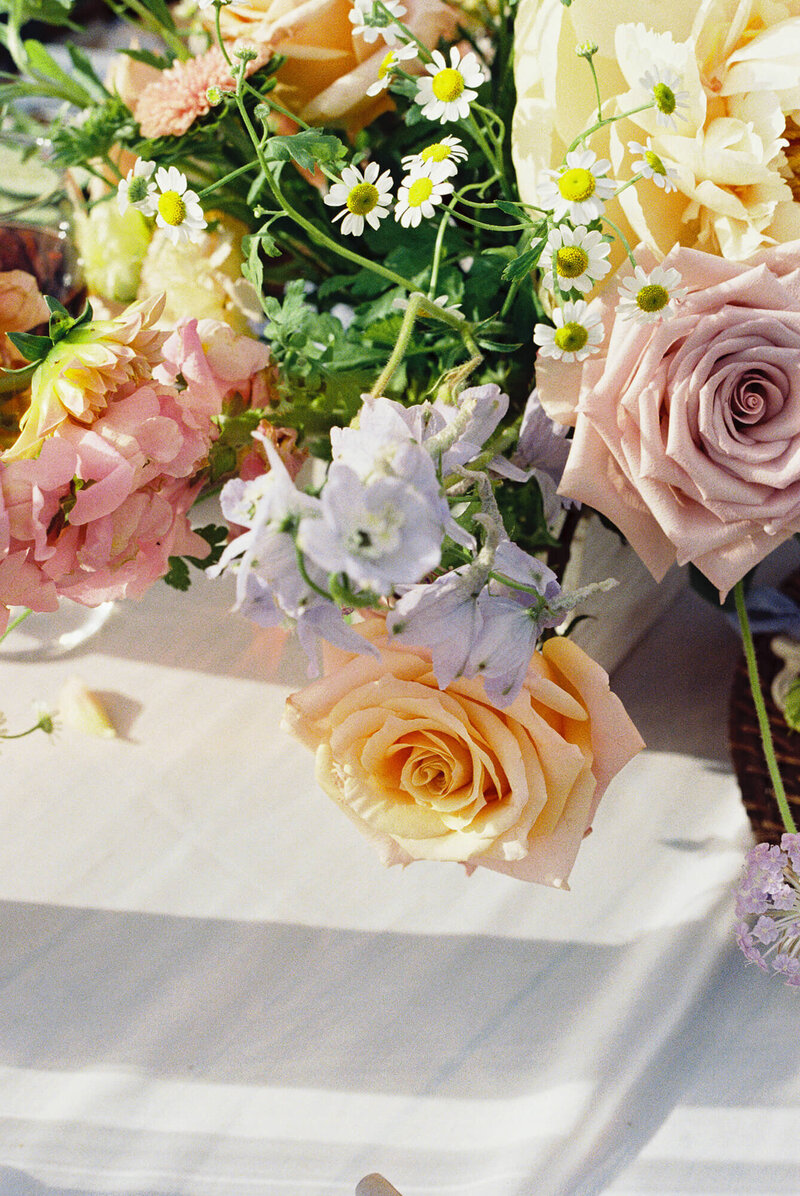 film shot of wedding centerpiece floral arrangement of red, blue, purple, yellow flowers at serendipity garden