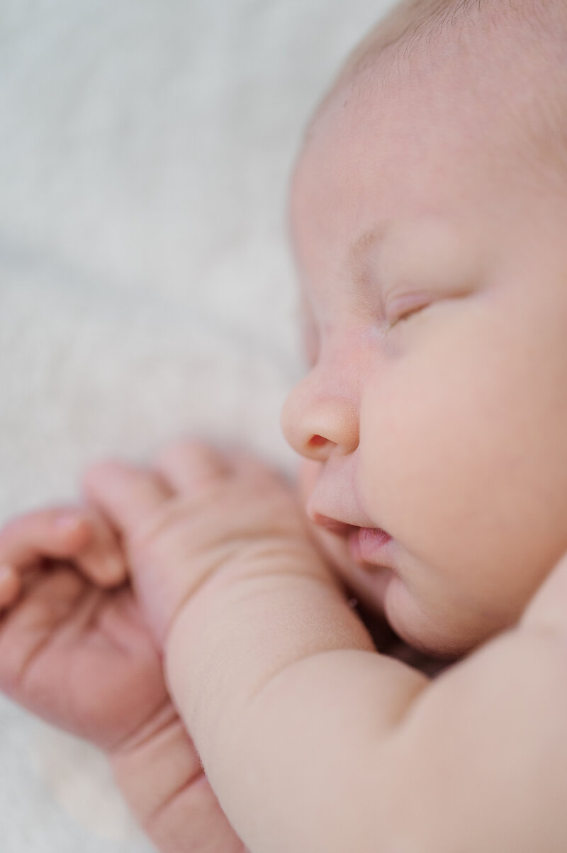 Newborn baby sleeping peacefully during in-home newborn photography session in York, PA.