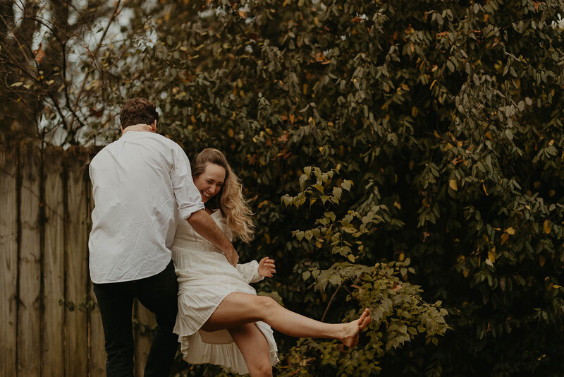 couple dancing and laughing in their yard