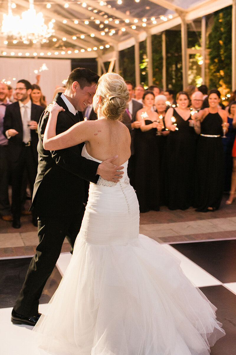 Newlyweds share their first dance underneath the stars at the Chicago Illuminating Company.