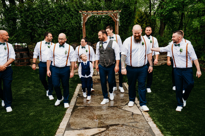 Groom and his nine groomsmen walking and laughing at each other
