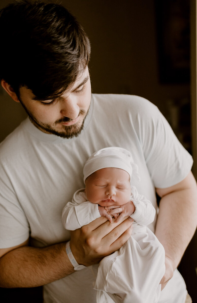 Father holding his newborn baby.