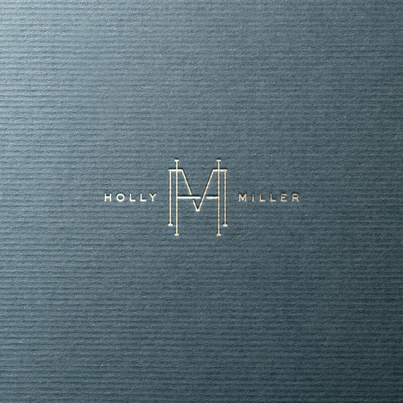 Gold HM monogram for Cake Design by Holly Miller on rich blue textured background