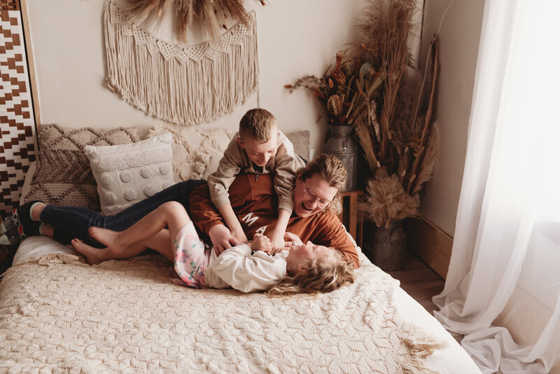 Photographer Nicole snuggles her own little ones in the downtown studio of Nikii Pix Photography