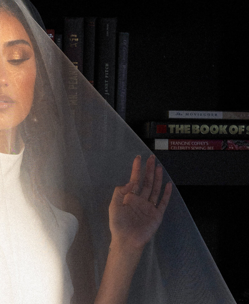 Bride under a translucent veil with soft natural lighting