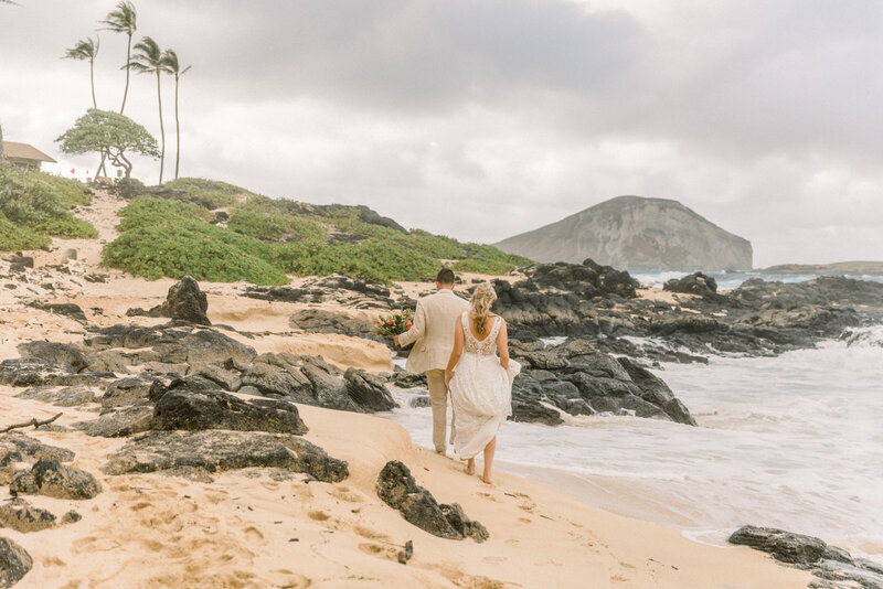 wedding day portrait of couple walking on the beach in Oahu Hawaii
