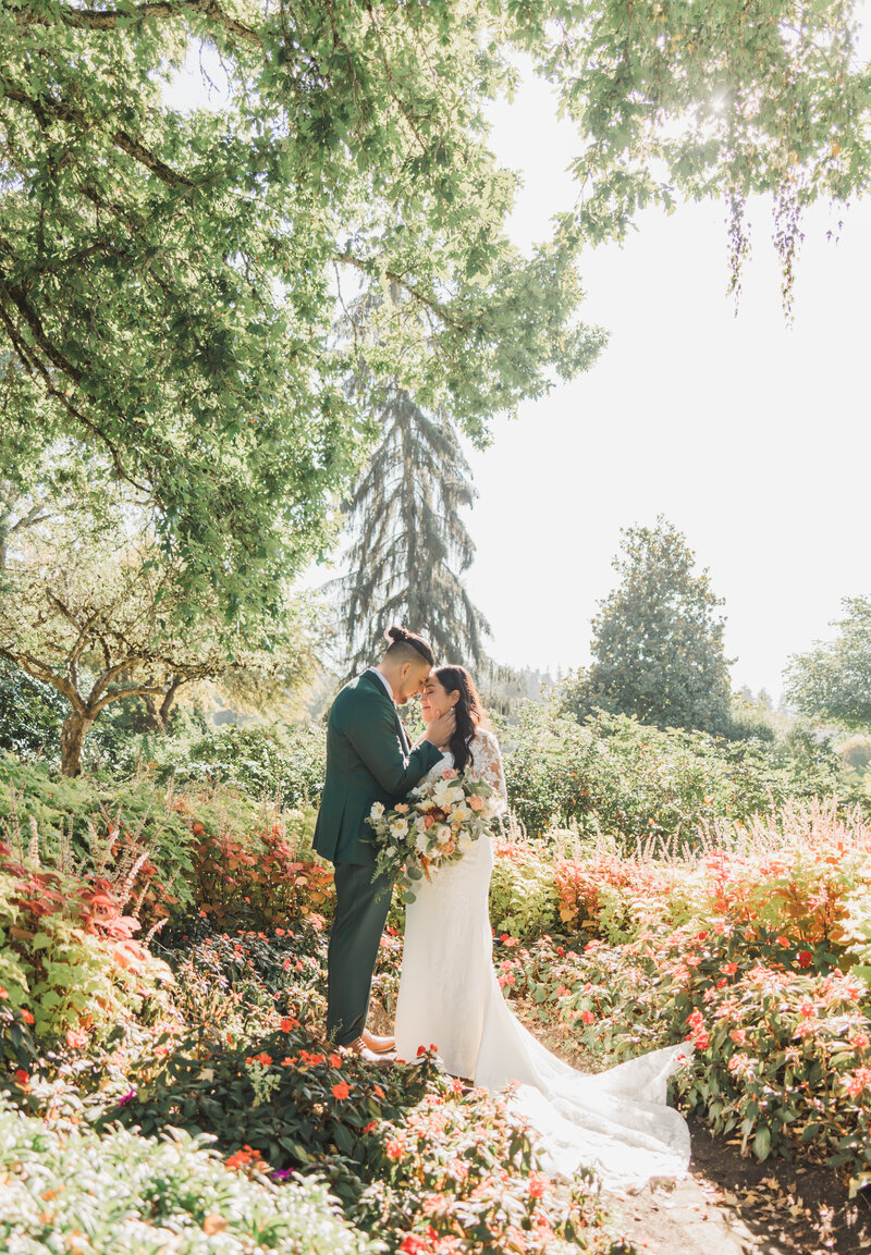 Tana & Eliot give a smooch after cutting the cake on their wedding day