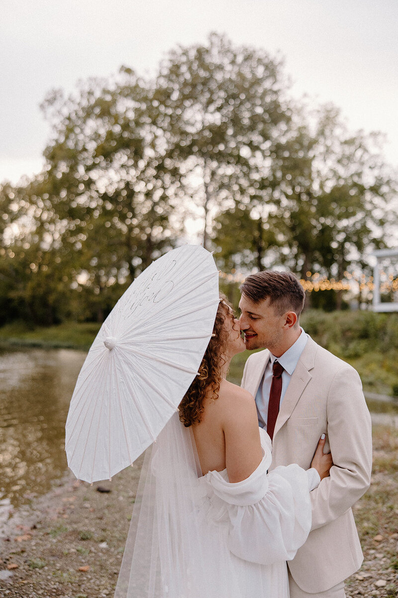 bride and groom kissing at alter