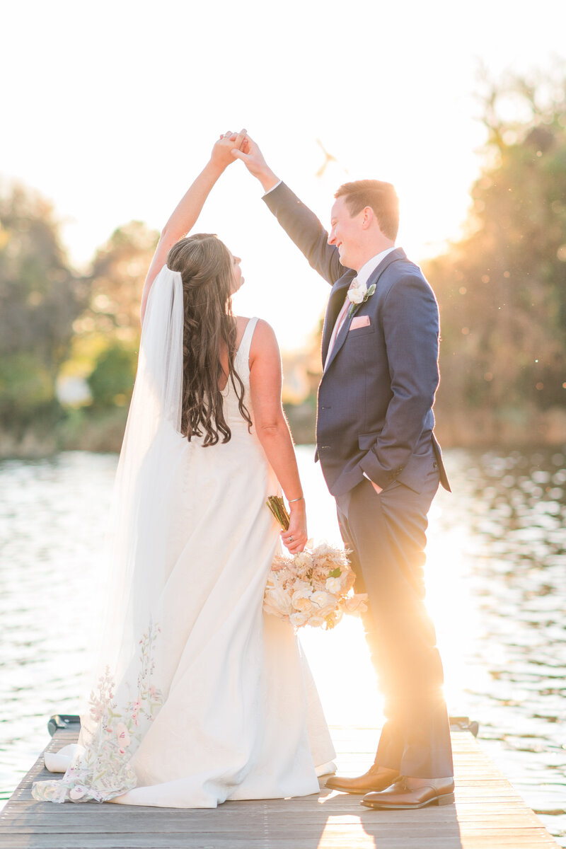 man twirling his bride on their wedding day