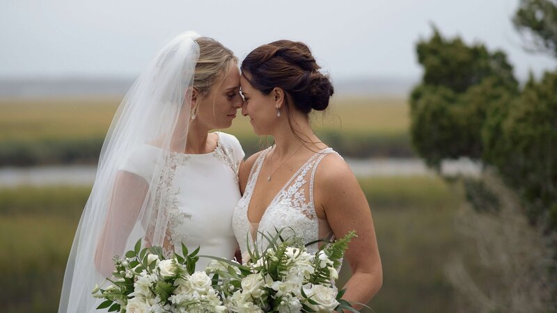 Lesbian brides touching foreheads at Walker's Landing Resort