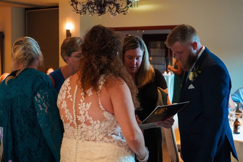 Colorado event planner looking over document with her clients