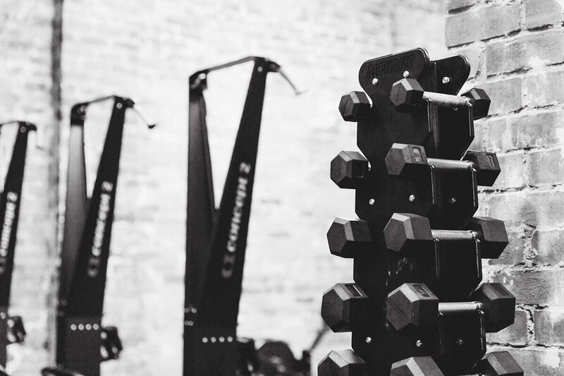 "Spacious gym interior showcasing modern equipment and an industrial aesthetic."