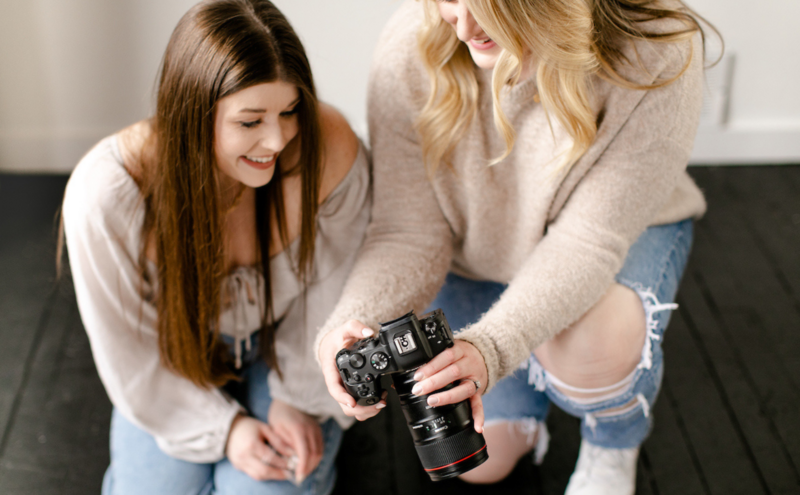 Photographer showing client photo on camera