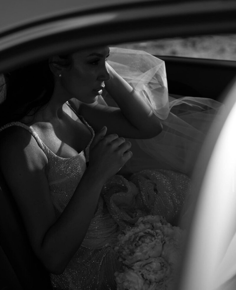 Serene bride seated in a car, reflecting moments before her wedding, embodying the grace and personalised touch of LIMCO's services.