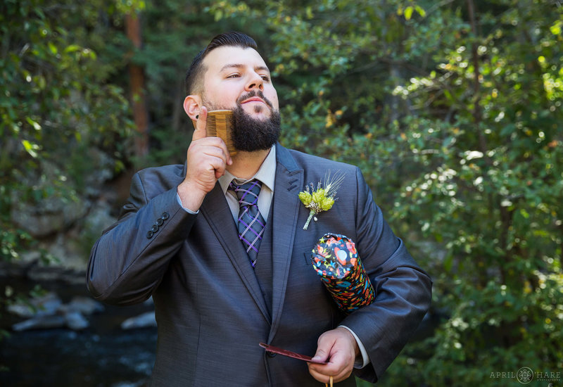 Groom combs his beard at the Bear Creek Cabins at Evergreen Colorado