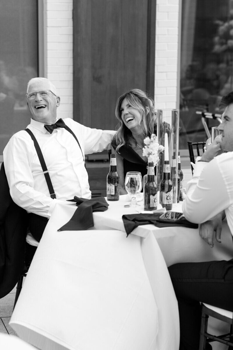 Cincinnati wedding photography of guests laughing at a wedding reception table