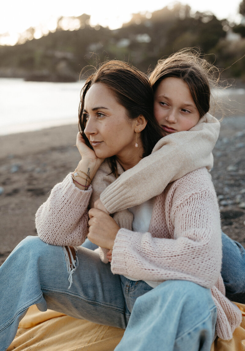 mom and daughter hugging during Muir beach photo session with a photographer in Mill Valley, Marin County 