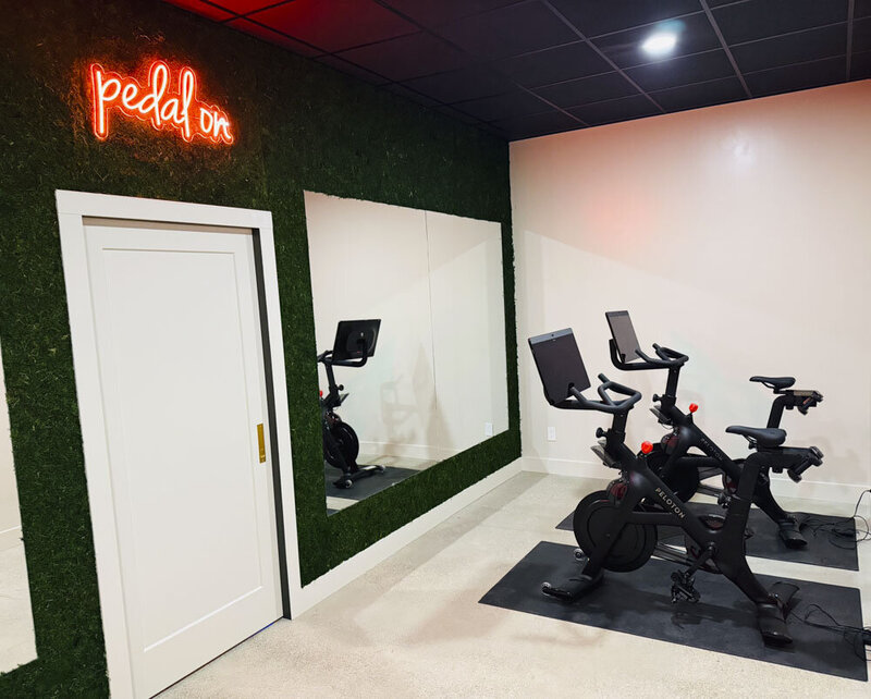 Peloton room at Salix - 2 stationary bikes in front of a mirror