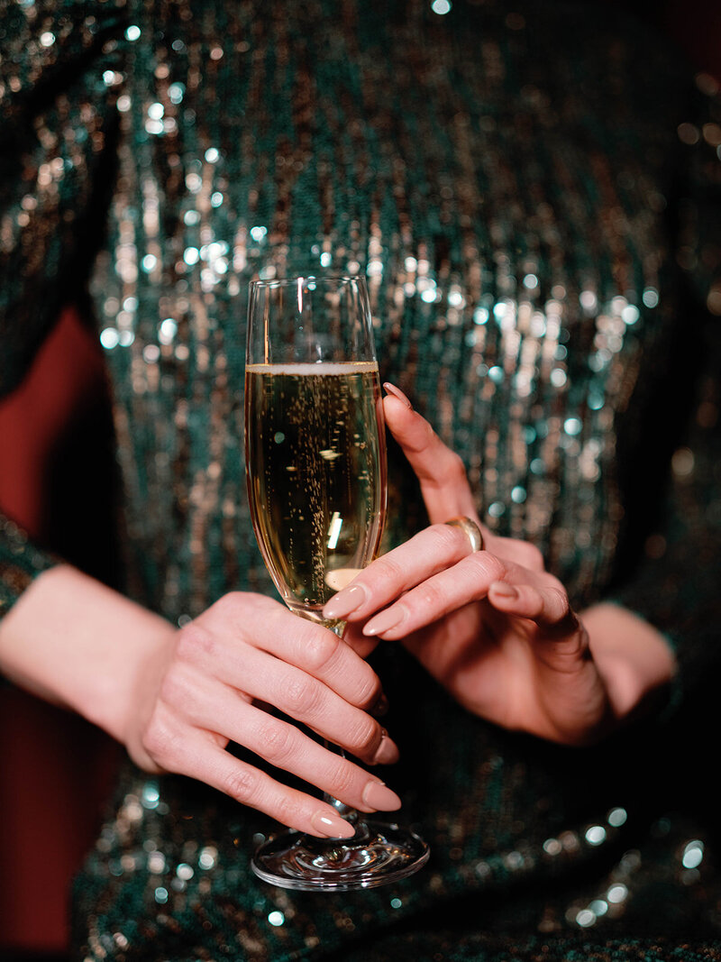 Close up photography of model holding champagne glass