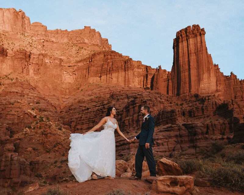 bride and groom holding hands