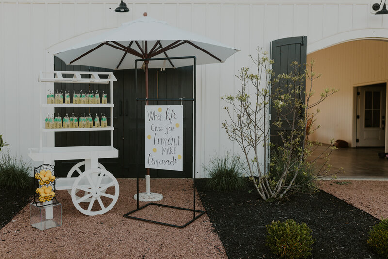 Lemonade stand and sign for a summer citrus inspired wedding