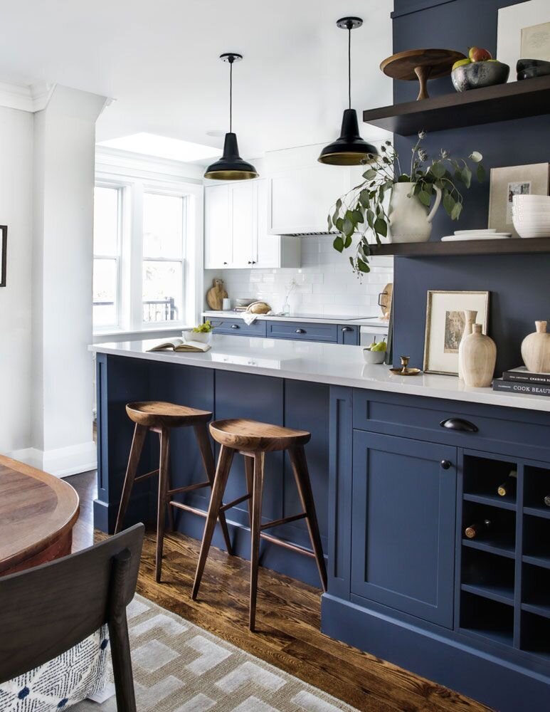 Kitchen remodel with a farmhouse vibe. Dark blue cabinetry with bright white walls and quartz countertops.