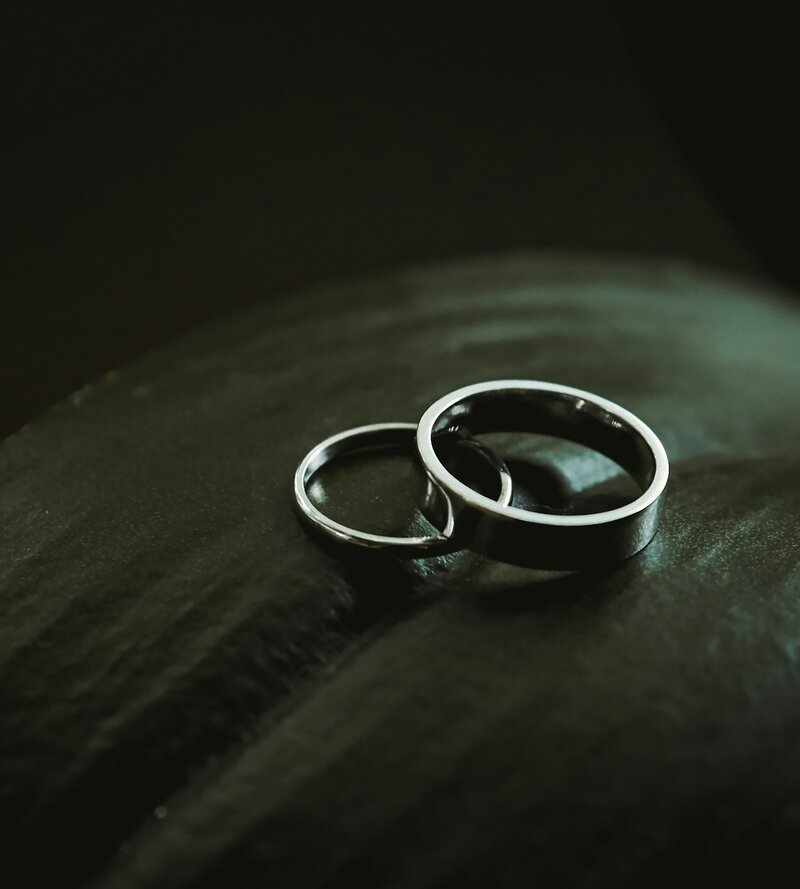 two wedding rings on a leaf