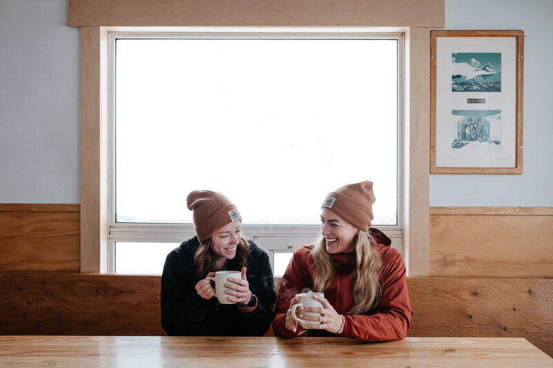 Photography team having coffee in a backcountry hut