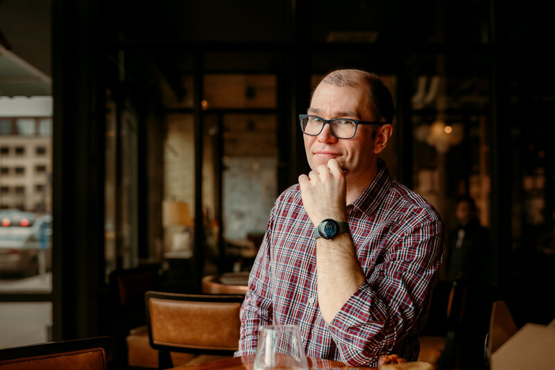 Ryan enjoying a casual restaurant setting during his Minneapolis dating profile photoshoot, relaxed and approachable