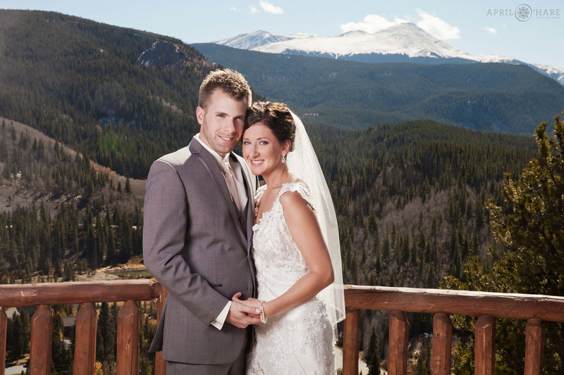 Sunny wedding day in Colorado couple posing on the Skyview Deck at The Lodge at Breckenridge