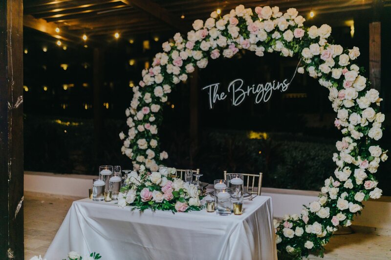 A wedding ceremony set up with flowers and a sign.