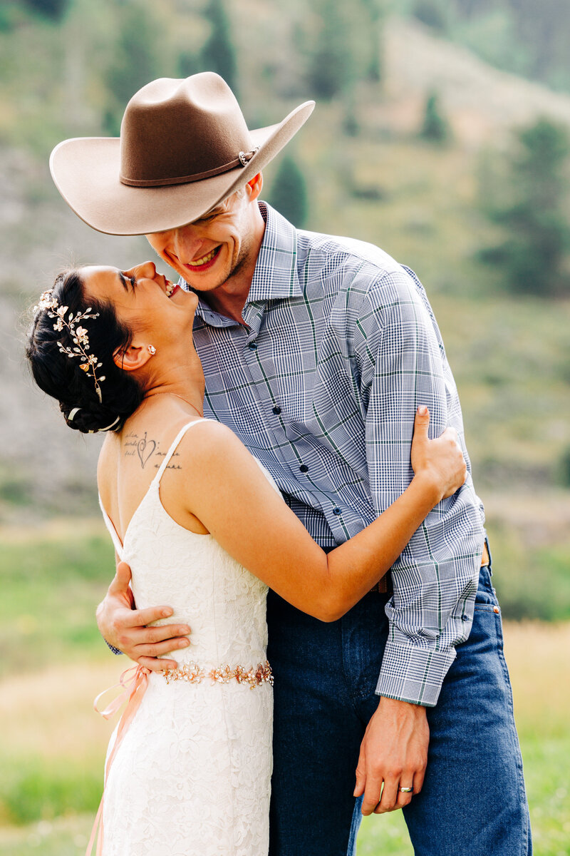 Western Montana bride and groom laughing together at Wilderness Edge in Cameron, MT